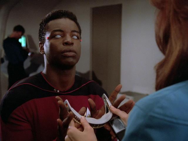 Dr. Crusher examines La Forge's VISOR